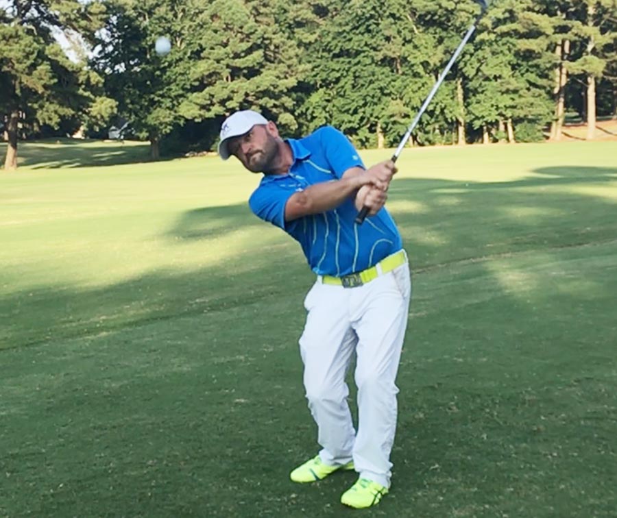 Tony Keeton teaches a golf lesson clients in Orlando